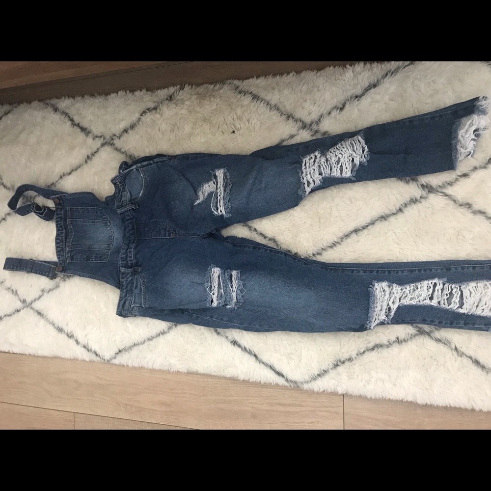 Distressed denim overalls.